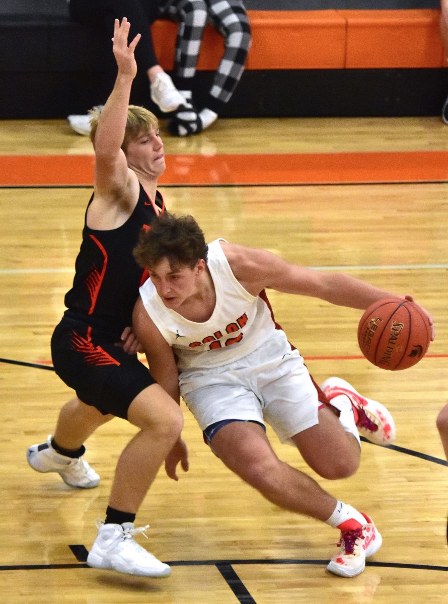 Vince Steinbrech (13) drives for the basket Friday, Dec. 8 at home against Grinnell. The Spartans improved to 2-0 with a 73-64 win including 17 points from Steinbrech, a senior.