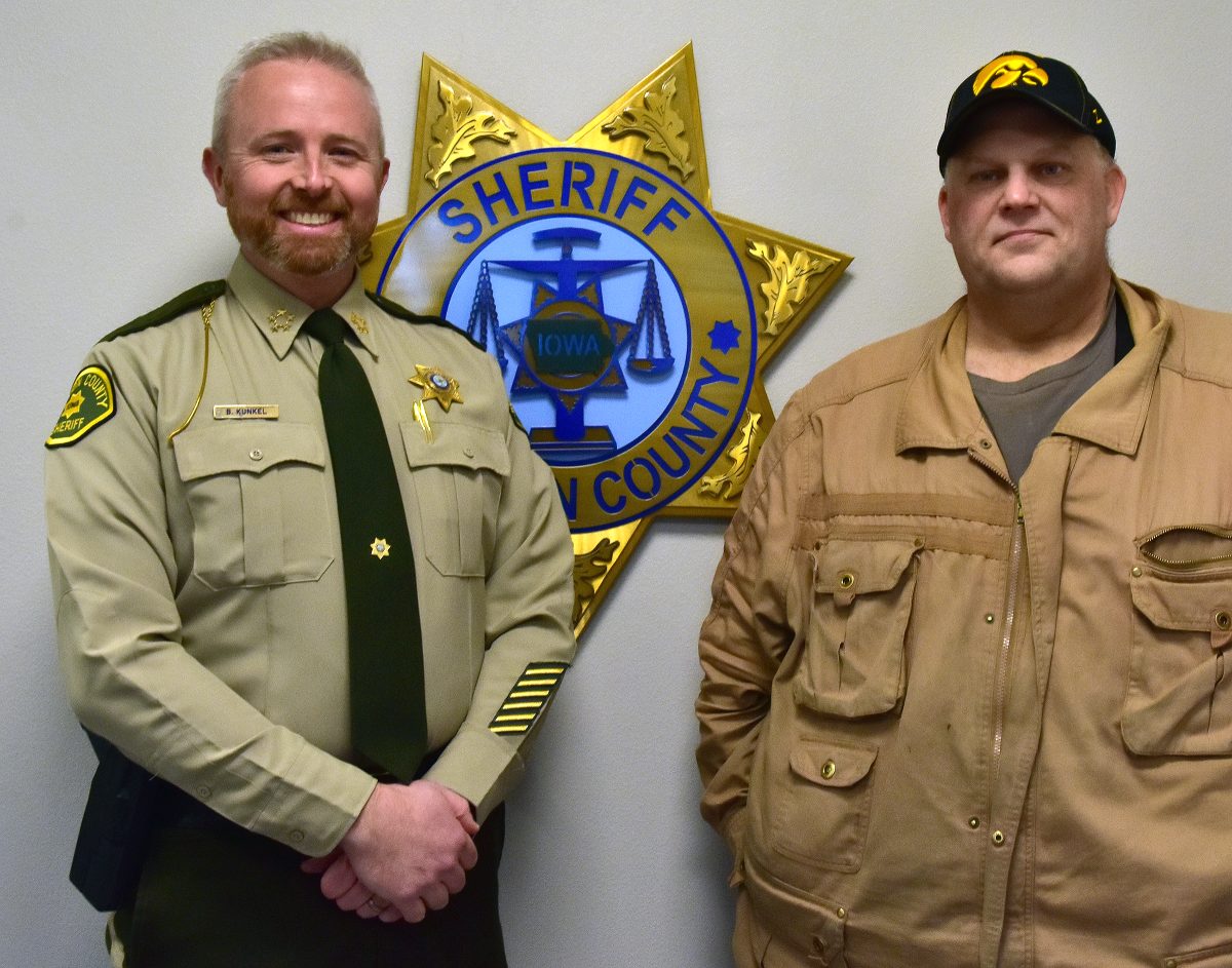 <p>Johnson County Sheriff Brad Kunkel and former Mayor Steve Stange stand by the Johnson County Sheriff’s Office logo in the new Solon substation during a January 6 open house. The facility is now officially the Steven R. Stange Public Safety Building in recognition of Stange’s career as a law enforcement officer and 30 years as a Solon volunteer firefighter.</p>