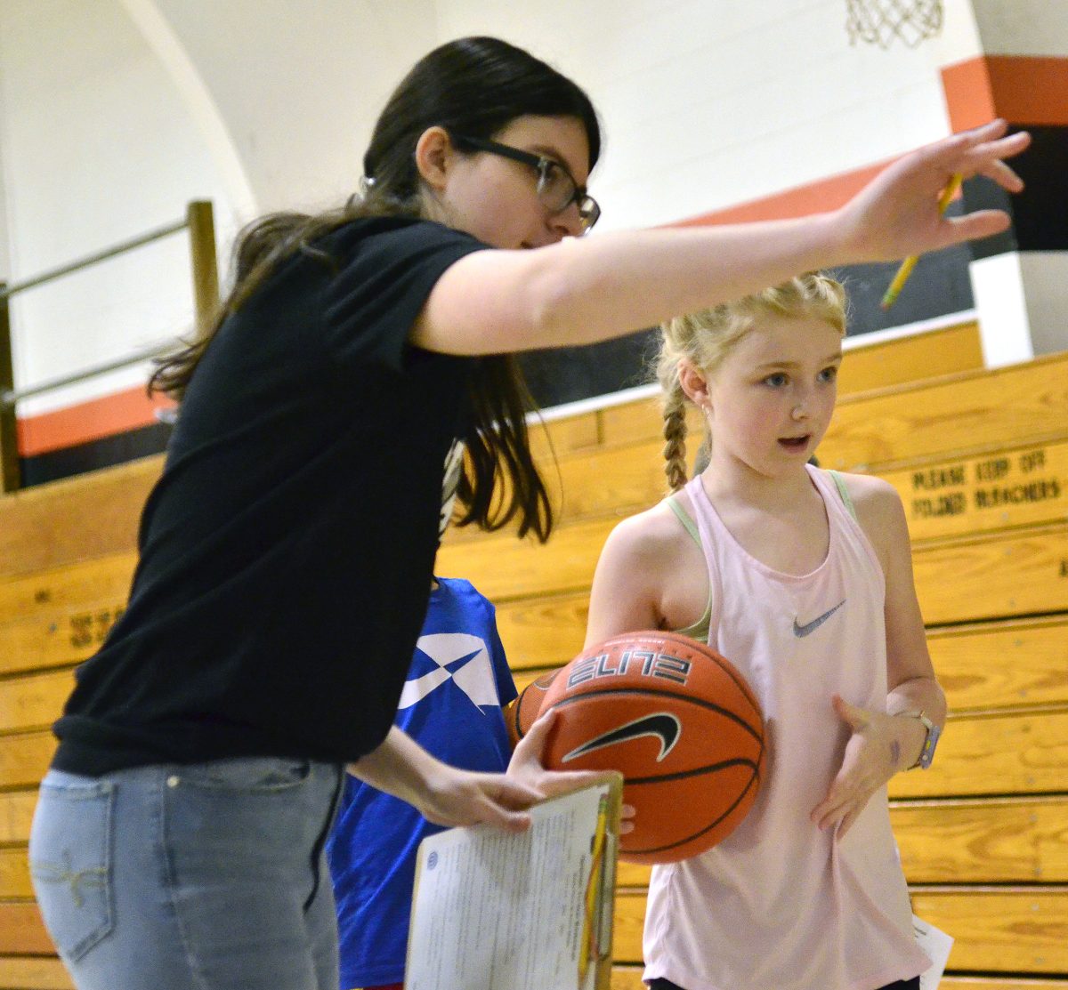 Jamison Grimm explains the bounce pass station to Lacey Scheib during Sunday&#8217;s Tri-Star Basketball Contests held by the Solon Optimist Club at the Community Center. Scheib won the girls ages 8-9 class.