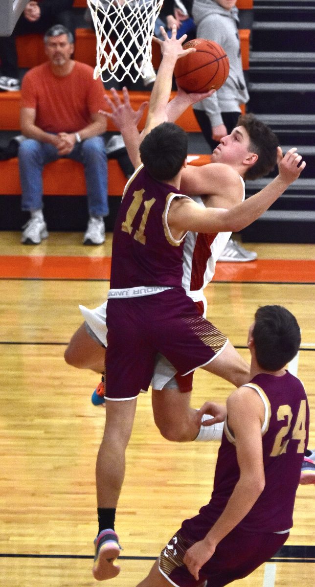 Vince Steinbrech (13) is fouled by Davis County&#8217;s Cason Young in a Class 3A Substate 5 first round game Monday, Feb. 19 in Solon. The Spartans rolled the Mustangs 75-36 to advance to the second round against Keokuk.