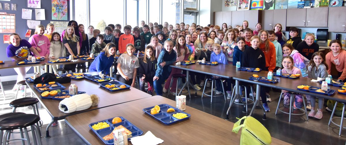 <p>Solon Intermediate School 4th and 5th grade students in the Optimists’ Alpha Club pose for a group photo with teacher Sami McAtee. McAtee leads the Alpha Club and was presented with the 2023 Achievement in Education Award last week.</p>