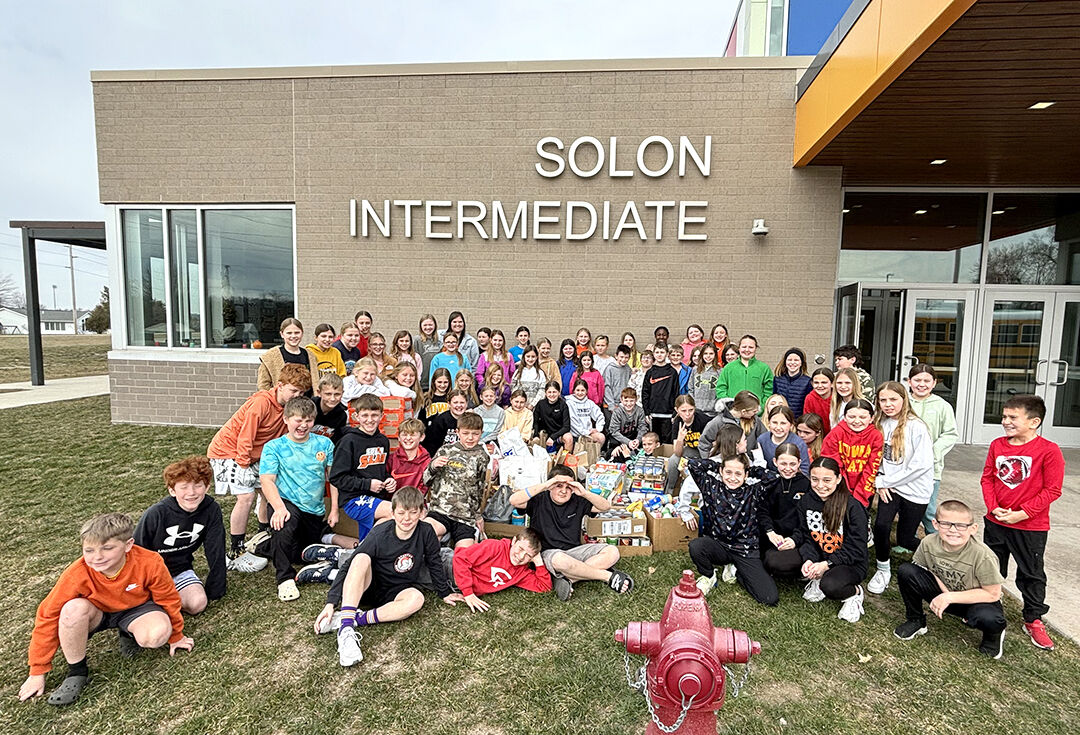 SIS Alpha Club members pose with roughly a half-ton of donated food they collected for presentation to the Solon Community Food Pantry recently.