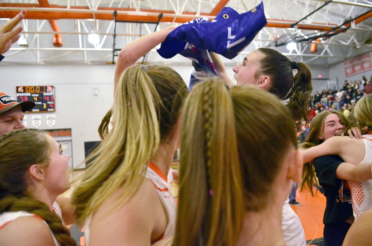 The Lady Spartans react to receiving the Class 3A Girls State Basketball Tournament Qualifier banner from Activities Director Casey Hack after defeating the Chariton Chargers 73-41 in a Regional Final Saturday, Feb. 17. The win sends Solon back to Wells Fargo Arena for the second year in a row.