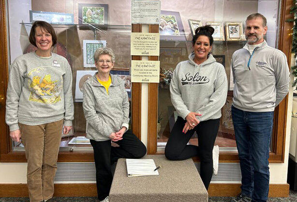 (From left): Liz King, Library Director, with Foundation members Kris Brown, Tina Steinbrech, and Bob King share a sampling of art on display at the Library.