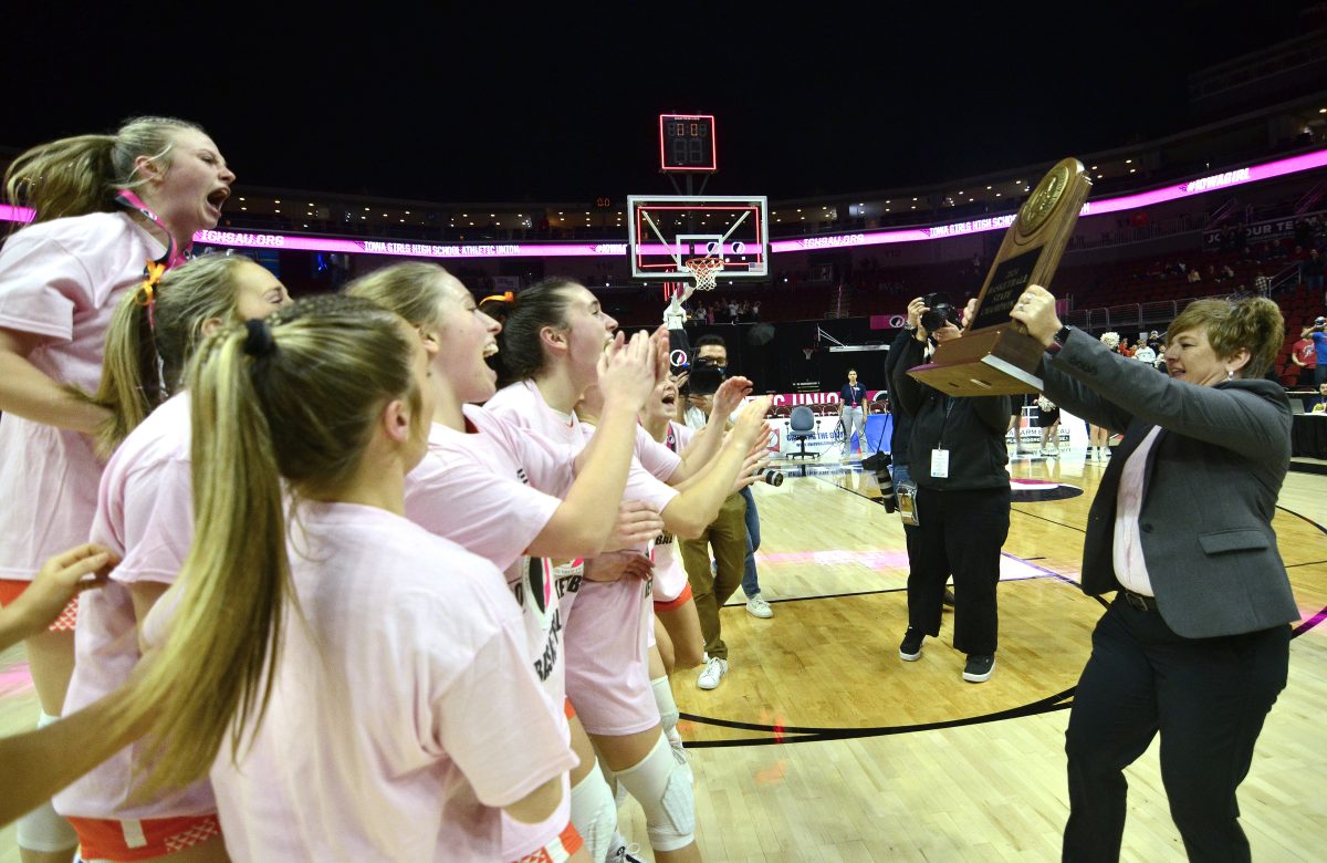 The Lady Spartans react to being presented with the 2024 Class 3A State Basketball Champions trophy Friday, March 1 after defeating Estherville-Lincoln Central 54-47 at Wells Fargo Arena in Des Moines. This is the first State Championship for the varsity girls since 1998 (Class 2A).