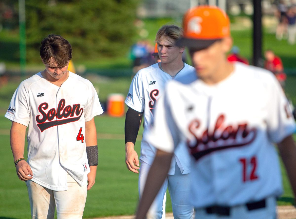 Gehrig Turner (4) and Brett White (right) head back to the dugout for the last time. These are two of the nine seniors that played their last game as a Solon Spartan.