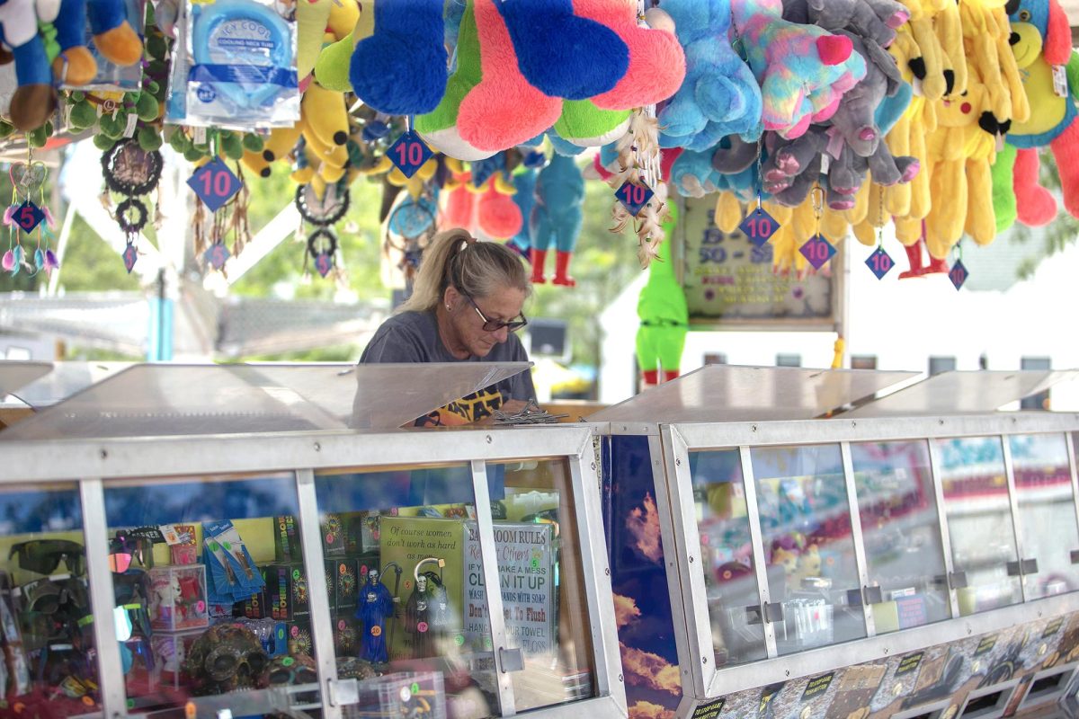 Sherri Nieukrik sets up a game on the carnival midway set up along West Main Street in downtown Solon. Nieukrik has run the carnival game for 16 years at Beef Days and said her favorite part of the festival is seeing all the people, both new and returning.