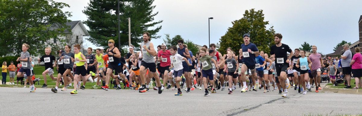 Runners cross Racine Ave. as they start the annual Beef Days 5k and 1-Mile run Saturday morning.