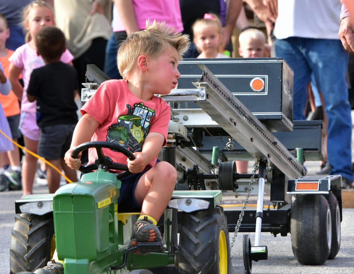 Rex Schmidt, from Solon, checks the sled as he competes in the 2024 Beef Days Kid’s Tractor Pull Friday, July 19. Schmidt made it 11’-9” for second place in the 35 pounds and under class.