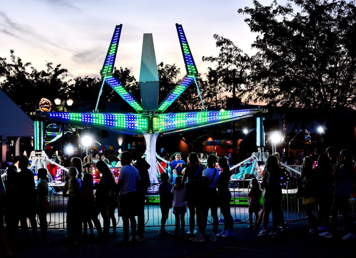 People stand in line for the Rockstar ride back-lit by the Sizzler in the Sam’s Mainstreet Market parking lot Friday evening. Sam’s Amusements & Carnival from Shawnee, OK returned to Beef Days and once again filled the lot and Main St. with rides and games.