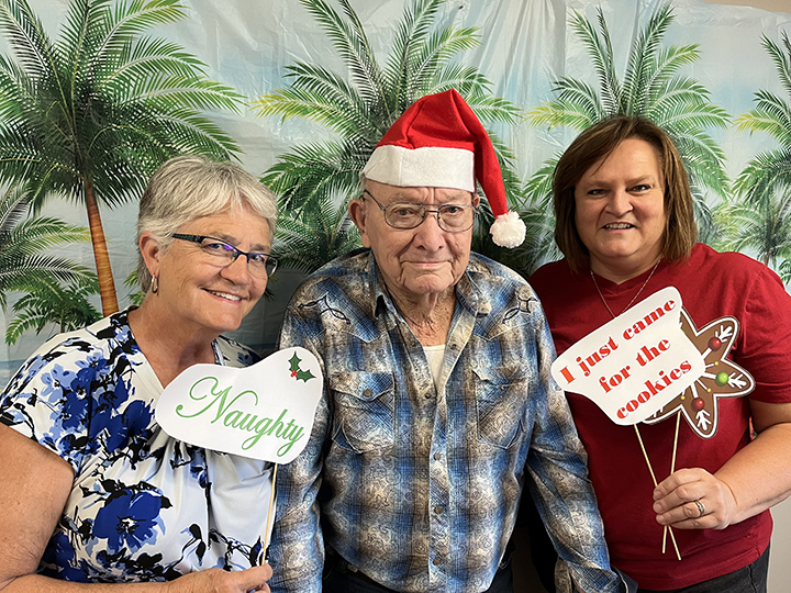 Elmer Smyth poses with his daughters Marilyn and Molly during the Solon Retirement Village’s Christmas in July event.