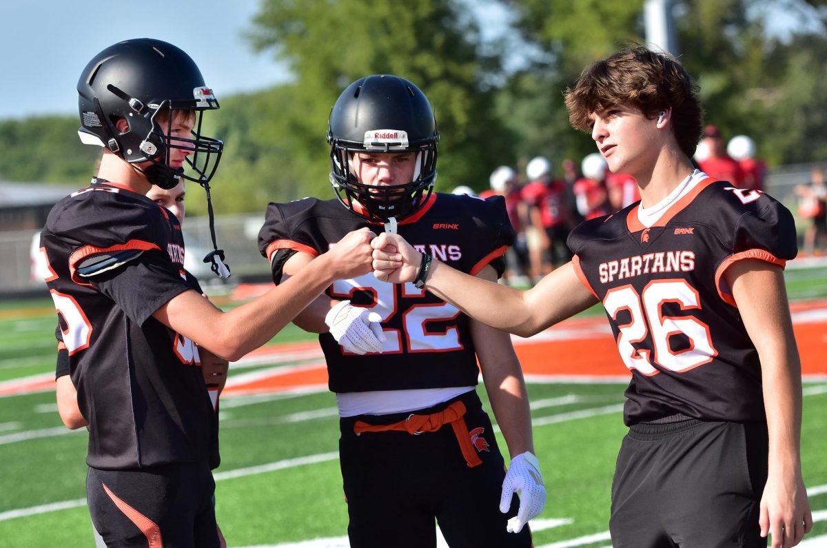 Freshmen Dayne Rickertsen (65), Ian Cronk (24), Foster Owens (22), and Sawyer Hancox (26) get ready for battle. The freshmen scrimmaged against Maquoketa this past Friday evening  in a non-scoring half-field game while the JV squad (sophomores) battled Monticello on the other half of the field before the varsity tangled with Maquoketa and Monticello in a triangular fashion.