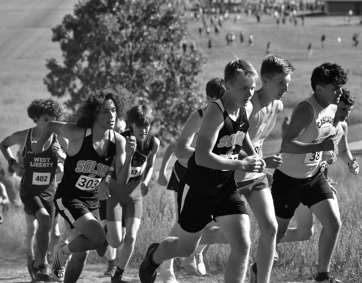 Rene Meza (303) and Gabe Nicholson (305) charge up the hill at the Kickers Soccer Complex in Iowa City during Regina Catholic’s Bob Brown Invitational last year.