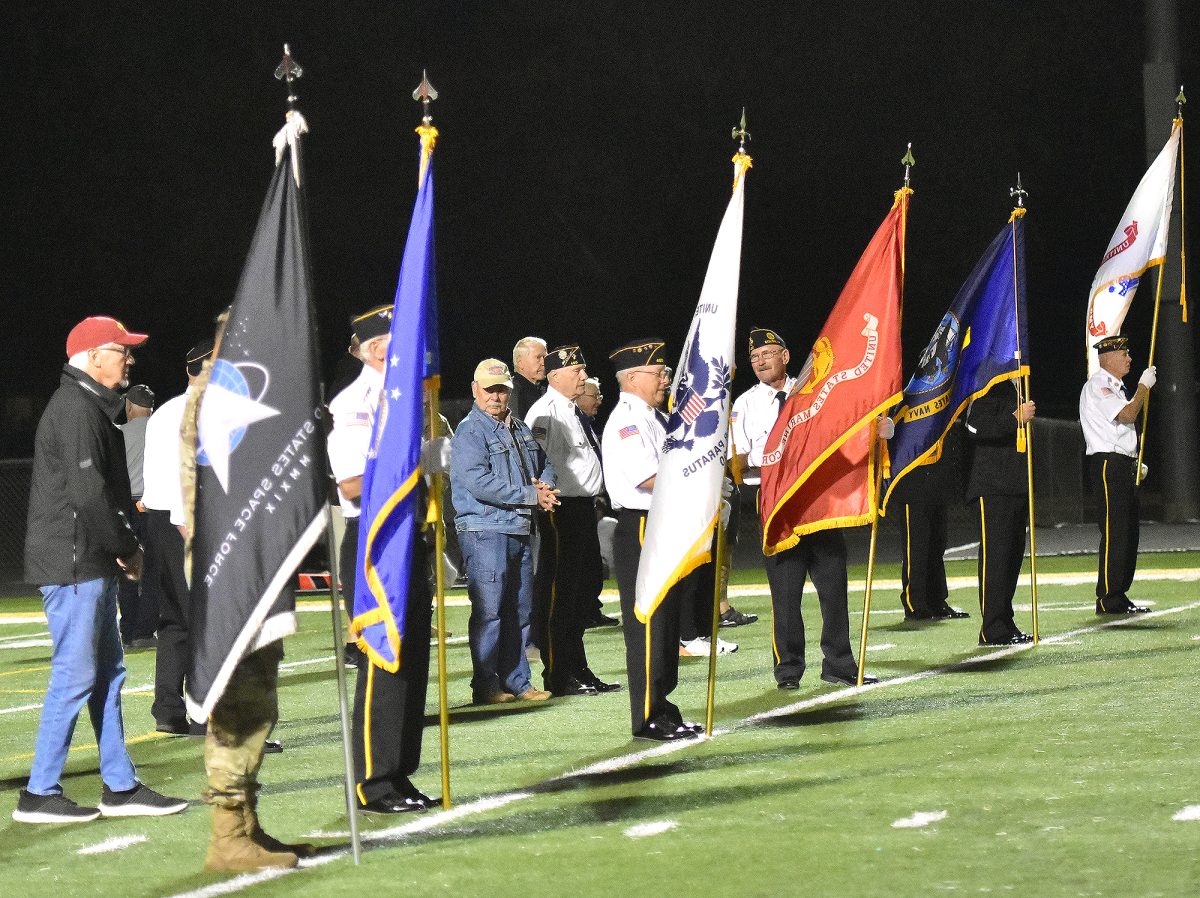 Denny Hansen, U.S. Army veteran, retired firefighter, and Sgt.
at Arms for the American Legion Stinocher Post 460 folds a
large American flag with help from sophomore football players
Nicholas Gerdin (22), Tripp Johnson (14), and Caden Bails (26) . The
sophomore team (JV) carried the flag onto the track for the pregame
ceremonies for last year’s Armed Forces Night. This year active duty
military personnel and veterans will be honored Friday, Sept. 20 at
the Mount Vernon vs. Solon football game in Spartan Stadium.