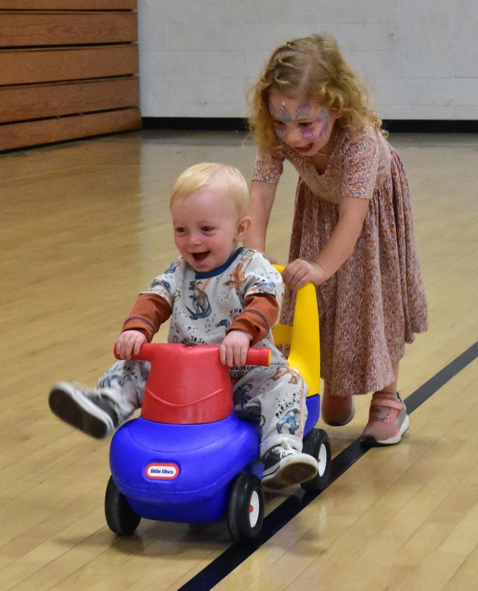 Mabel Kremer takes
Finn for a fast ride in the gym at the Solon Community Center as the September Fun For All Night gets underway. The free monthly event gives kids an hour to burn off energy before settling in for a movie.
