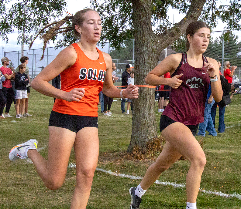 Sydney Dee battles her way to a 4th overall finish in the Women's Varsity race Monday in Solon’s home invitational meet.