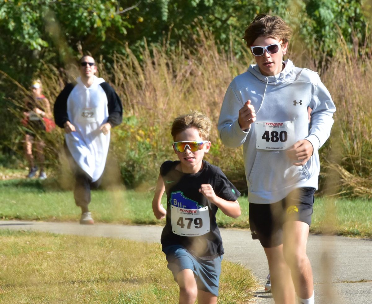 Lewis Ekroth (479) and Sam Ekroth (480), from Solon dash through an S-curve at the SRNA Saturday morning during the third annual Bone Dash. The pair finished fourth and fifth in the 1-mile run, which raised funds for the Joining Hands Support Group for pediatric rheumatology patients at the U of I Stead Family Children’s Hospital.