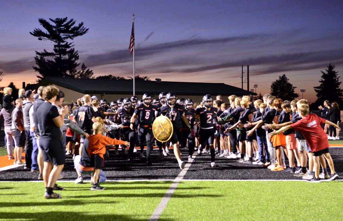 The Varsity Spartans storm the field passing through a tunnel formed by Solon’s 2024 youth football teams for the Homecoming Game vs. the Grinnell Tigers this past Friday. The Spartans remained undefeated with a 26-7 win.