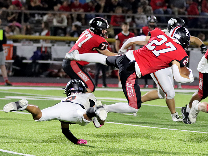 Karsyn Regennitter (2) dives for Williamsburg’s Nile Sinn in varsity action Friday, October 11 in Williamsburg. Sinn racked up 101 yards of rushing on 22 carries and went 67 yards on one pass reception (for a touchdown) to keep the Spartan defense busy.