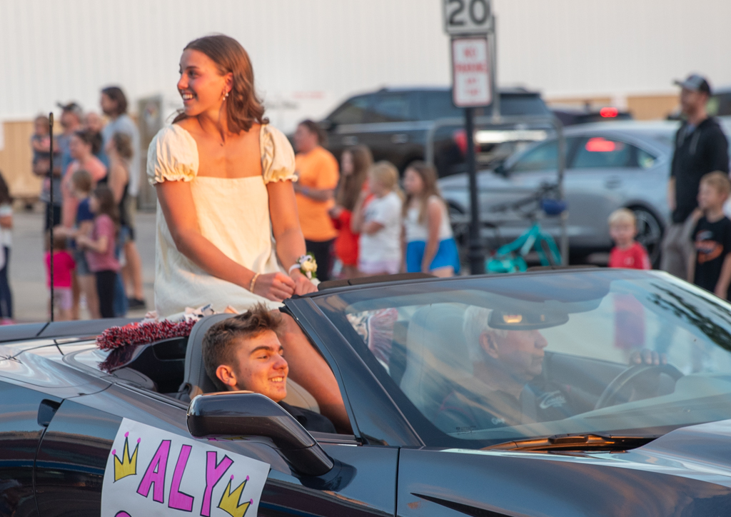 Aly Stahle smiles from the back of a corvette during the 2024 Homecoming Parade last Wednesday. Stahle was crowned the Homecoming Queen at halftime of the varsity football game Friday.