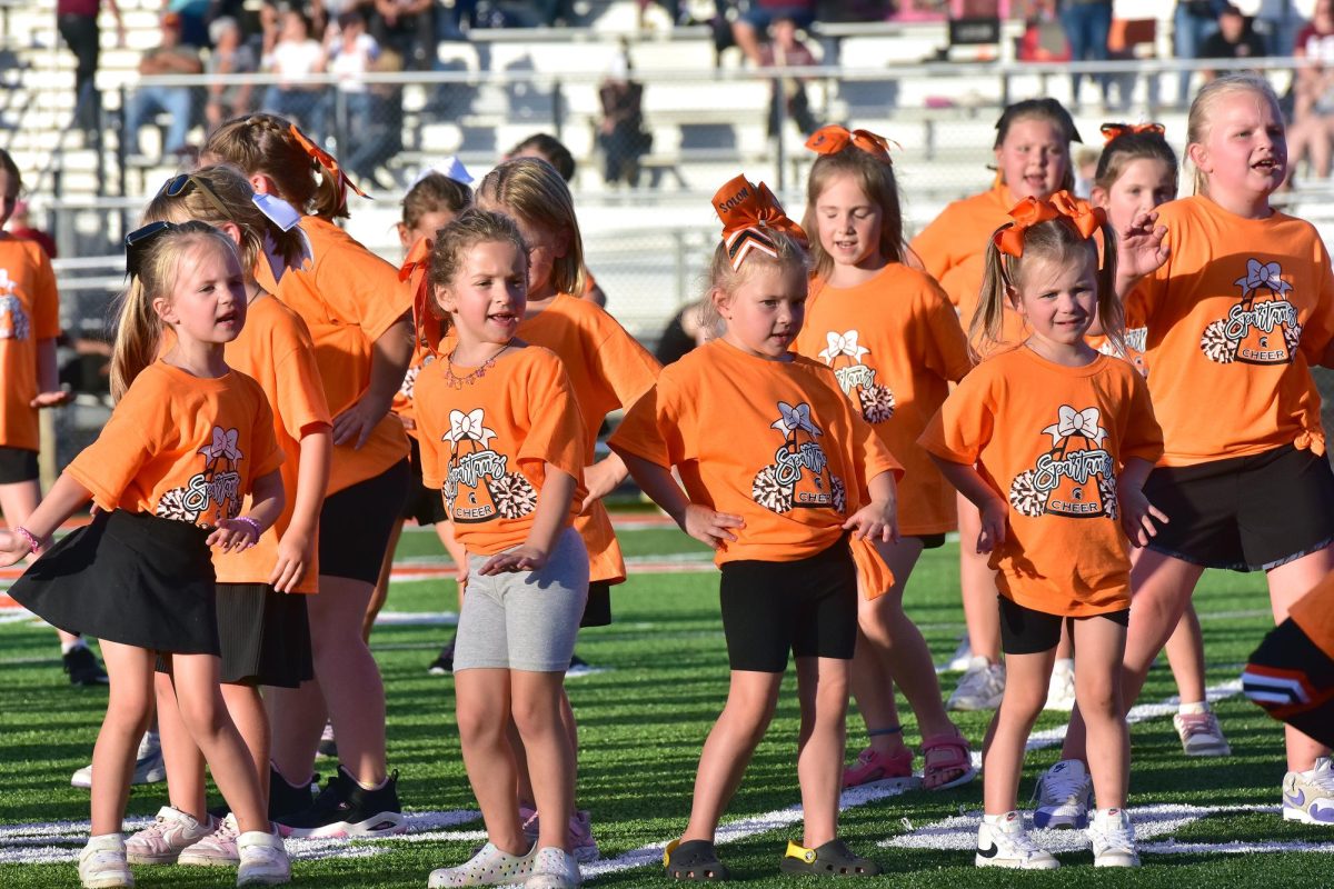 High school cheerleaders work with Pre-K through fifth grade girls during halftime of the JV game Friday, Sept. 20.