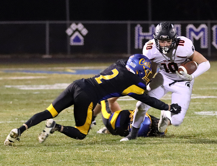 Senior Eddie Johnson (10), attempts to escape a Humboldt Wildcat after disposing of another while grinding out yardage Friday, Nov. 8 in a Class 3A Quarterfinals game against the Humboldt Wildcats in Humboldt. The Wildcats ended the Spartans’ season with a 35-3 loss.