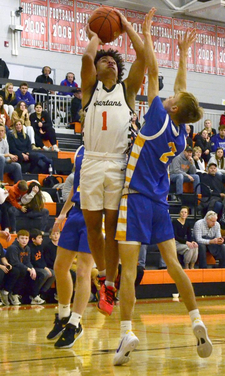 Karsyn Regennitter (1) puts up two of his 11 points at home against Benton Community Friday, Dec. 13. The Spartans dominated the Bobcats 66-46.