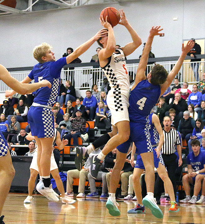 Caleb Bock zips by his opponents as he drives toward the net at Solon High School Friday, Dec. 6 against Clear Creek Amana. The Spartans defeated the Clippers 57-47.