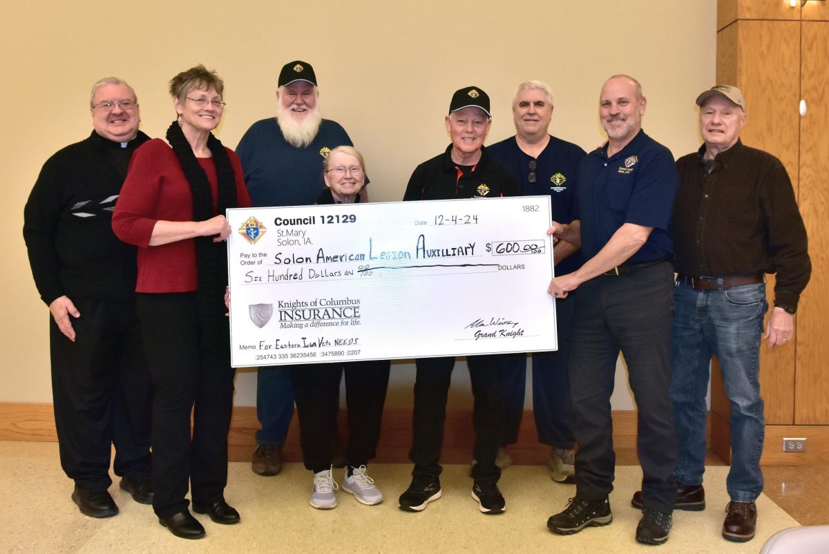 (From left) Fr. Charles Fladung, Patti Montgomery Mullnix (President, Solon American Legion Auxiliary), Kevin Hayes, Linda Linderbaum (Secretary, Solon American Legion Auxiliary), Bill Wieland, John Donatelli, Al Wieskamp (Grand Knight, Council 12129), and Doug “Doc” Thompson pose with a $600 check the Solon Knights of Columbus presented to the Solon American Legion Auxiliary to help eastern Iowa’s veterans in need.