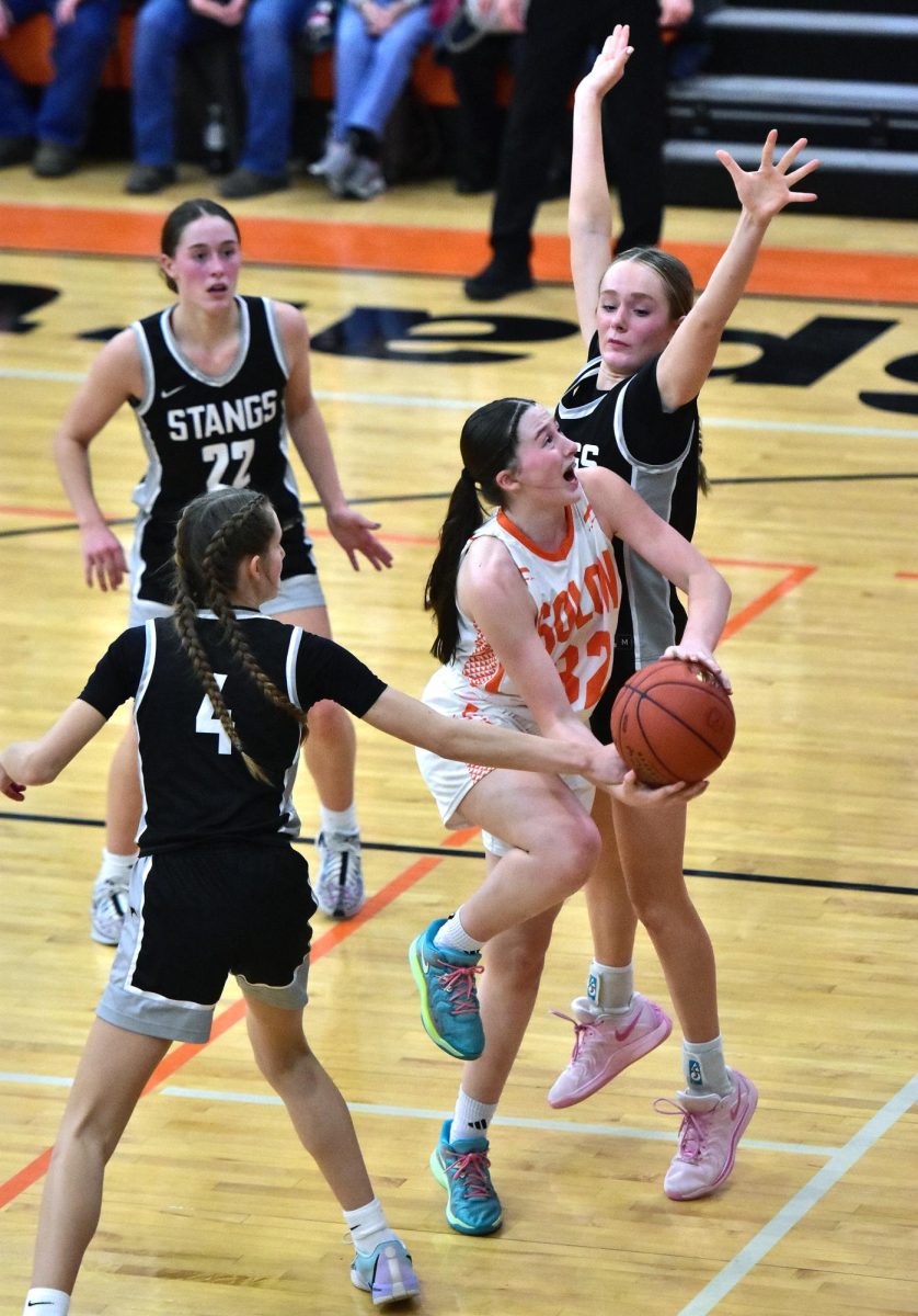 Freshman Beckett Kruse (32) is fouled by Mount Vernon freshman Quinn Pershing 4) in varsity action Friday, Jan. 24. The No. 1-ranked Mustangs rolled past the Lady Spartans 57-33.