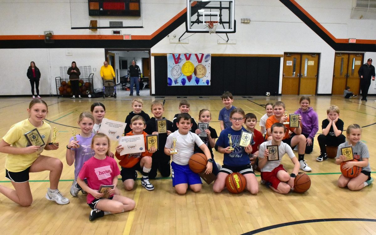 Participants in the Solon Optimist Club’s and Knights of Columbus’ annual basketball events pose with their trophies, plaques, and certificates Sunday, Jan. 26, in the gym of the Solon Community Center.