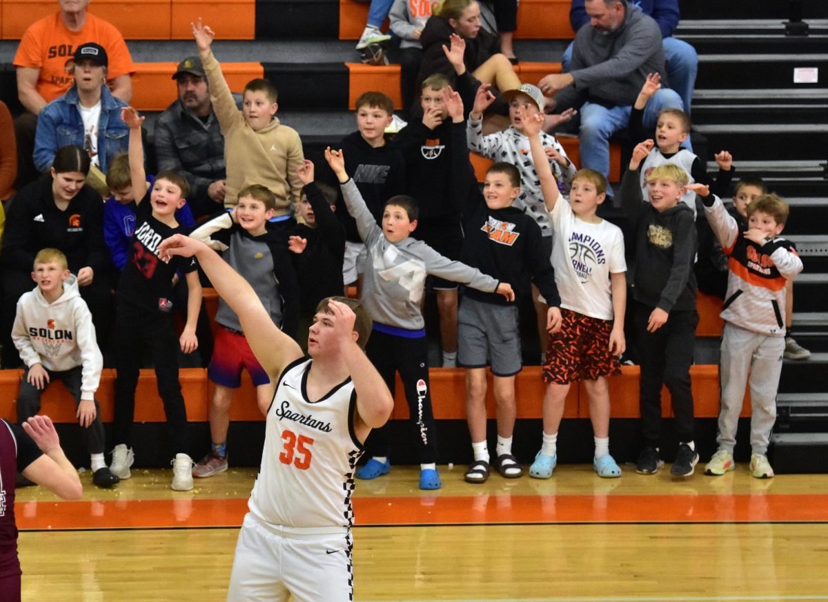 Jackson Link (35) gets a little help with a three-point shot from some enthusiastic young Spartans
Friday, Feb. 7 at home against Independence. Link was among nine seniors recognized on Senior Night.