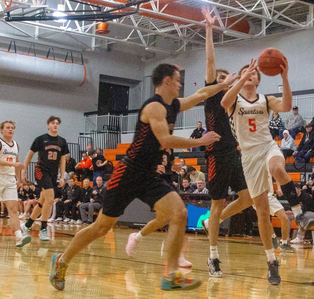 Caleb Bock drives through two defenders on his attack to the rim. Bock was dominant on the interior versus the Washington Demons with a game high 31 points in an 85-50 non-conference win Thursday, Feb. 20. 