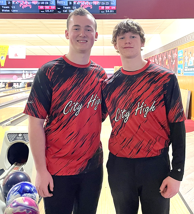 Solon high school students Carson Reid and Trendon Walker pose for a photo during a competition between Iowa City City High School and Xavier High School. Reid and Walker compete for City High’s bowling team, as Solon
does not have a bowling team.