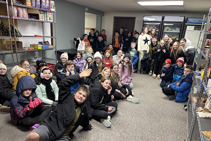  SIS Alpha Club members pose for a group photo after delivering over 1,200 pounds of food to the Solon Community Food Pantry. 