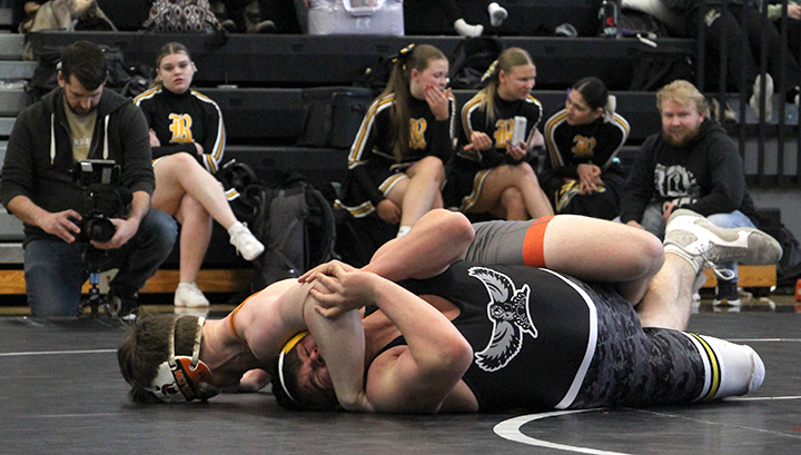 Solon’s Kyler Jensen and Mid-Prairie’s Brock Fisher wrestle during 2A Districts at Williamsburg High School Saturday, Feb. 15.