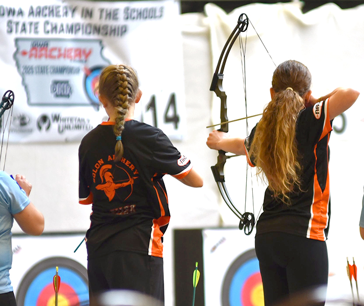 Abigail Allen and Leila LaRoche (at left) and Trevin Wilcox and Gwen LaGrange (at right) take aim during their flights at the 2025 Iowa National Archery in the Schools Program (NASP) State Tournament at the Iowa State Fairgrounds. The high school Spartans took second place in Bullseye (traditional target) competition. Solon's high school and middle school teams advanced to Nationals in May.