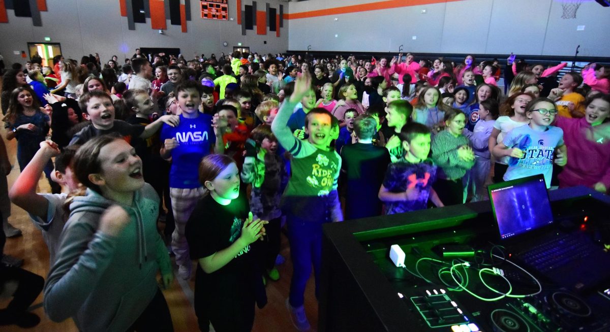 Nico Olsem (middle front), Solon Intermediate School 4th and 5th graders, and Solon Middle School 6th 
graders dance to the tunes spun
by “DJ Curtis (SMS teacher Curtis Hendrickson)” during a mini-dance
marathon last Friday afternoon. SMS students organized to raise money
for two area families battling cancer. .