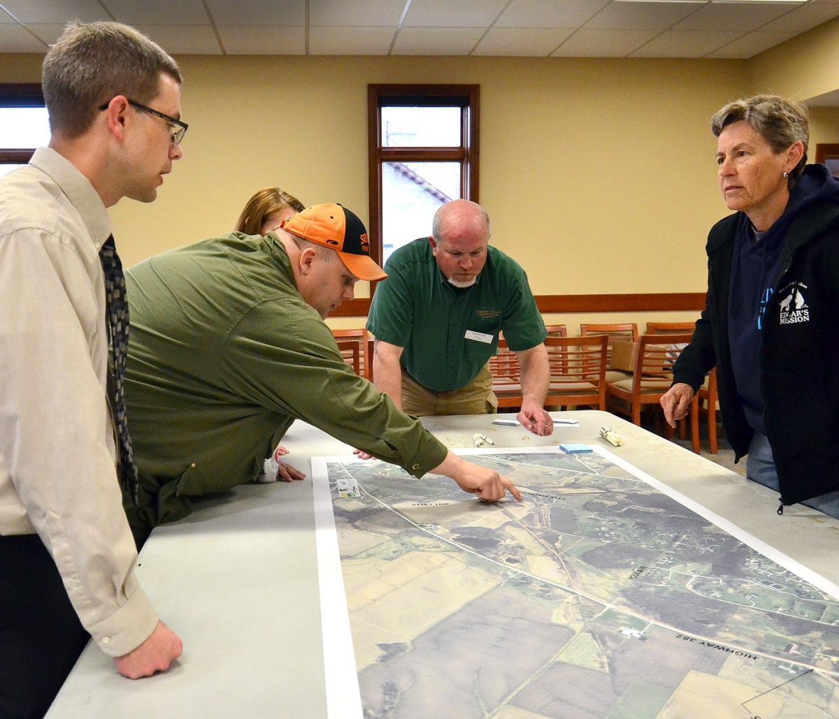 Bryan Benjamin (far left) of McClure Engineering and Brad Freidhof (middle), then the Johnson County Conservation’s Program Manager, answer questions about extending the Hoover Trail to Solon during a 2015 public information gathering in the Solon City Hall. Freidhof has been named Executive Director of Johnson County Conservation succeeding the late Larry Gullett.