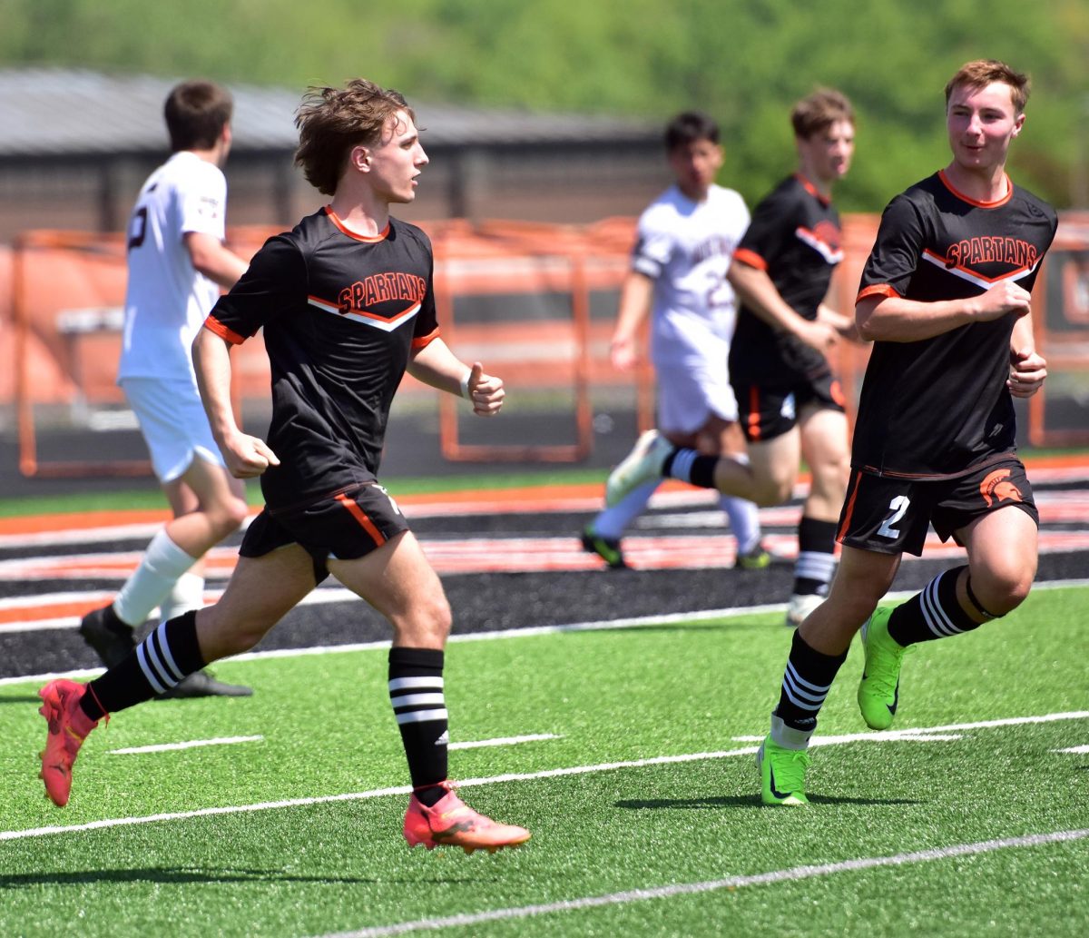 ucker Spence celebrates his equalizing goal with 27:30 left in the first half of a varsity match against rival Mount Vernon Saturday, May 10, as Ethan Ulch (2) congratulates him. The Spartans and Mustangs ended in a 2-2 tie.