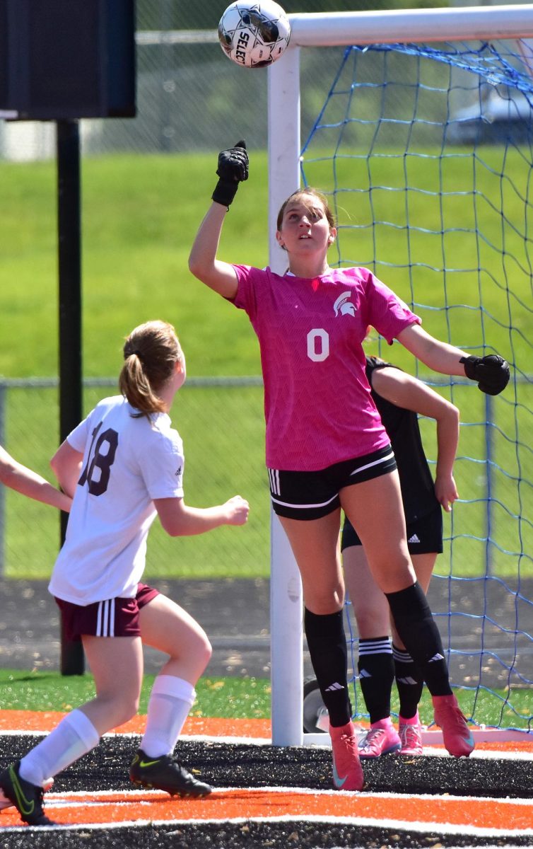 Junior keeper Gable Knight punches the ball away from the goal for a save Saturday, May 10, in Solon. 