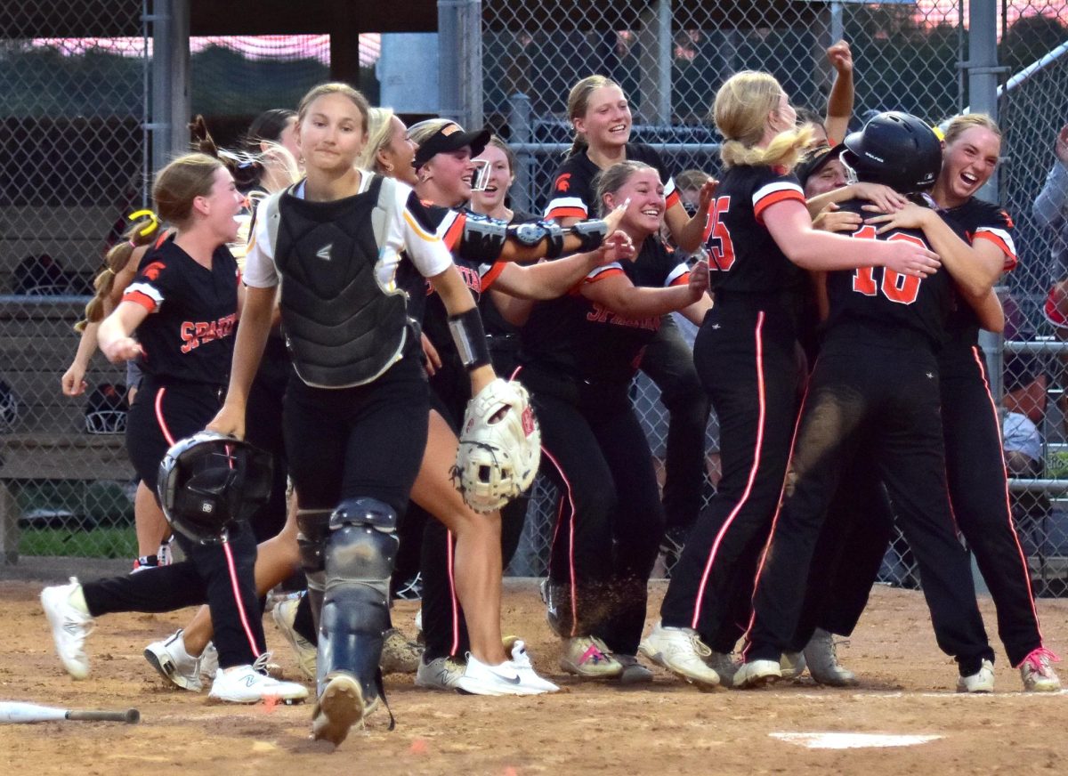 The Lady Spartans swarm Keegan Kleppe (18) after she scored the
winning run in a 3A Regional Championship against Center Point-Urbana. Laeni Hinkle drove in Kleppe in the bottom of the 7th inning breaking a 3-3 tie and sending Solon to the State Tournament for the first time since 2016.
