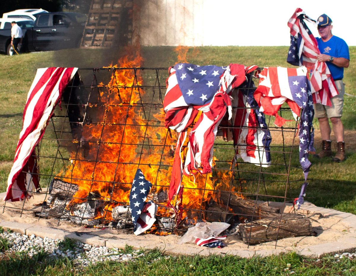 A member of Solon American Legion Stinocher Post 460 brings more flags to
the rack for disposal during the Post’s annual Flag Retirement Ceremony Saturday, June 14.