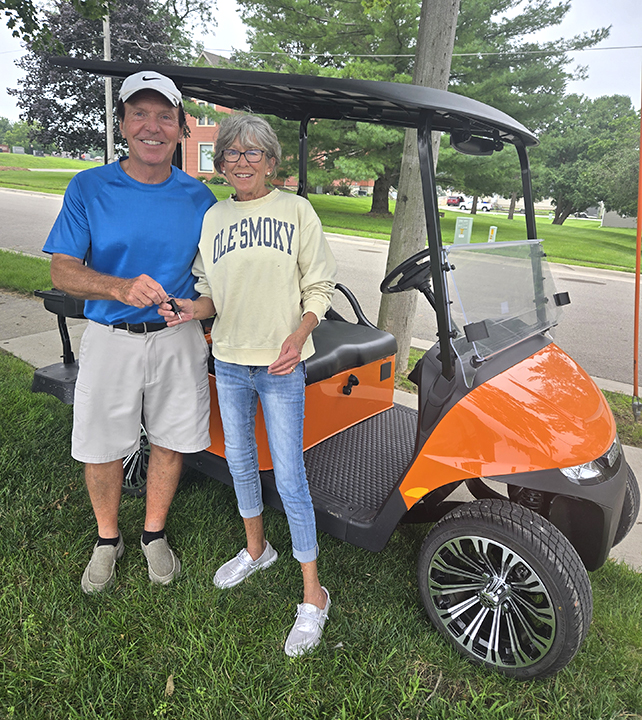 Beef Days Committee Treasurer Don Ellis presents Janice Brugman with the keys to her brand new golf cart. Brugman is the 2025 winner of the Beef Days golf cart raffle.