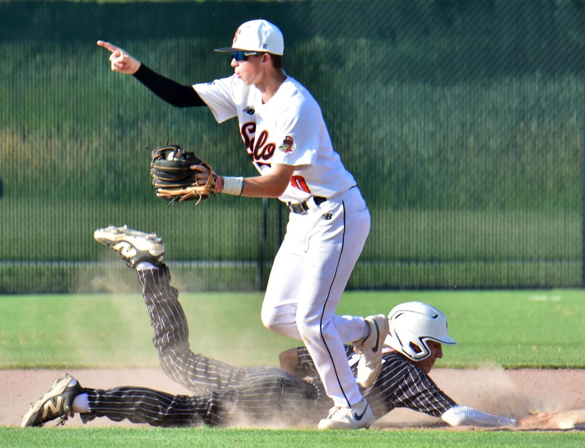 Brady Wick, a sophomore, sign signals an out ending the Stormin’ Pointers’ half of the seventh inning of game two Thursday, June 26 at home after gunning down CPU’s Geovanni Perez on a dive back to second base.