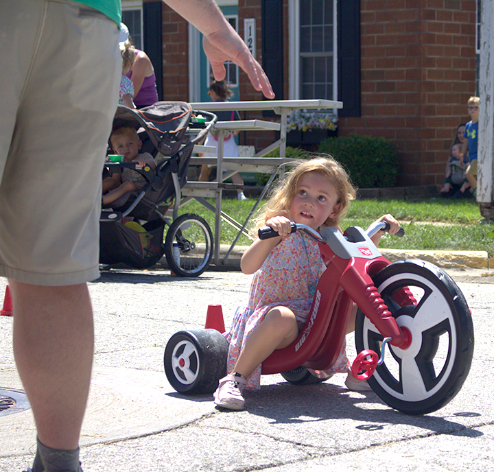 Mable pulls ahead to win a heat of the annual Big Wheel Races Saturday, July 19 in the Solon Beef Days Kid’s Corner.