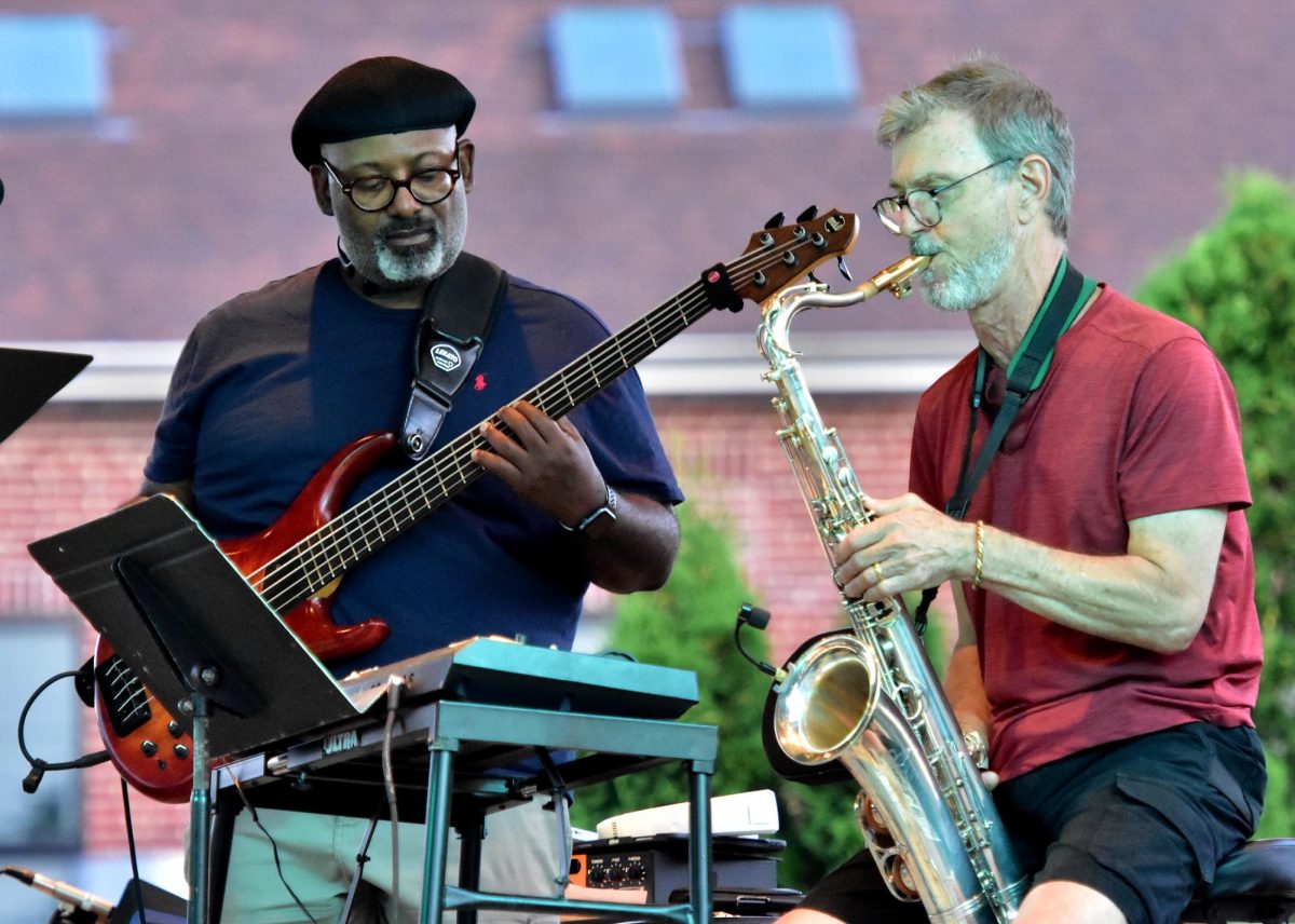 Ken Fullard (bass and vocals) keeps the rhythm going while Dave Shawver wails on the saxophone as the Funk Daddies rock downtown Solon with their mix of R&B and soul music Wednesday, July 23 during the Music on Main Street concert series.