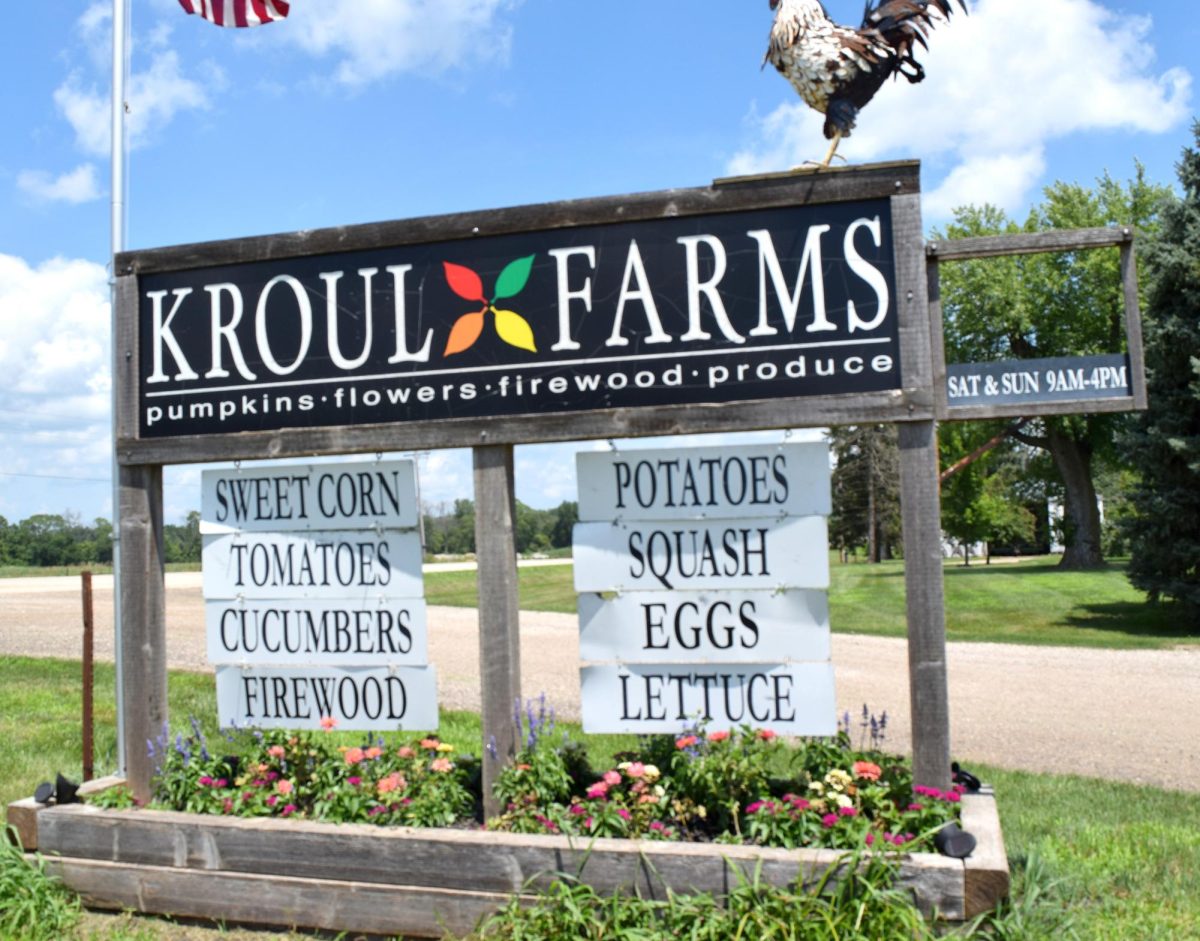 Kroul Farms displays a roadside sign advertising fresh items for sale including sweet corn, tomatoes, potatoes, eggs, and more.