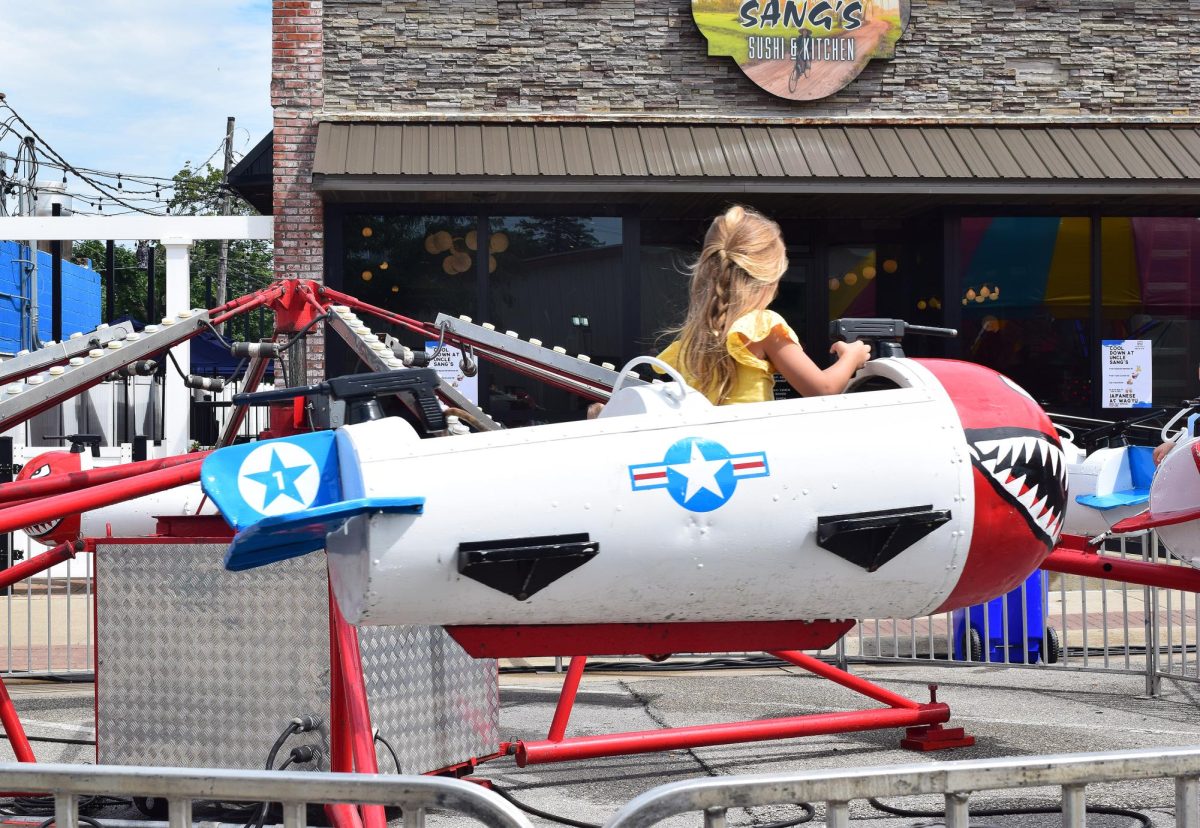 Mille Phab rides a carnival ride on Main Street Saturday morning during Beef Days.
