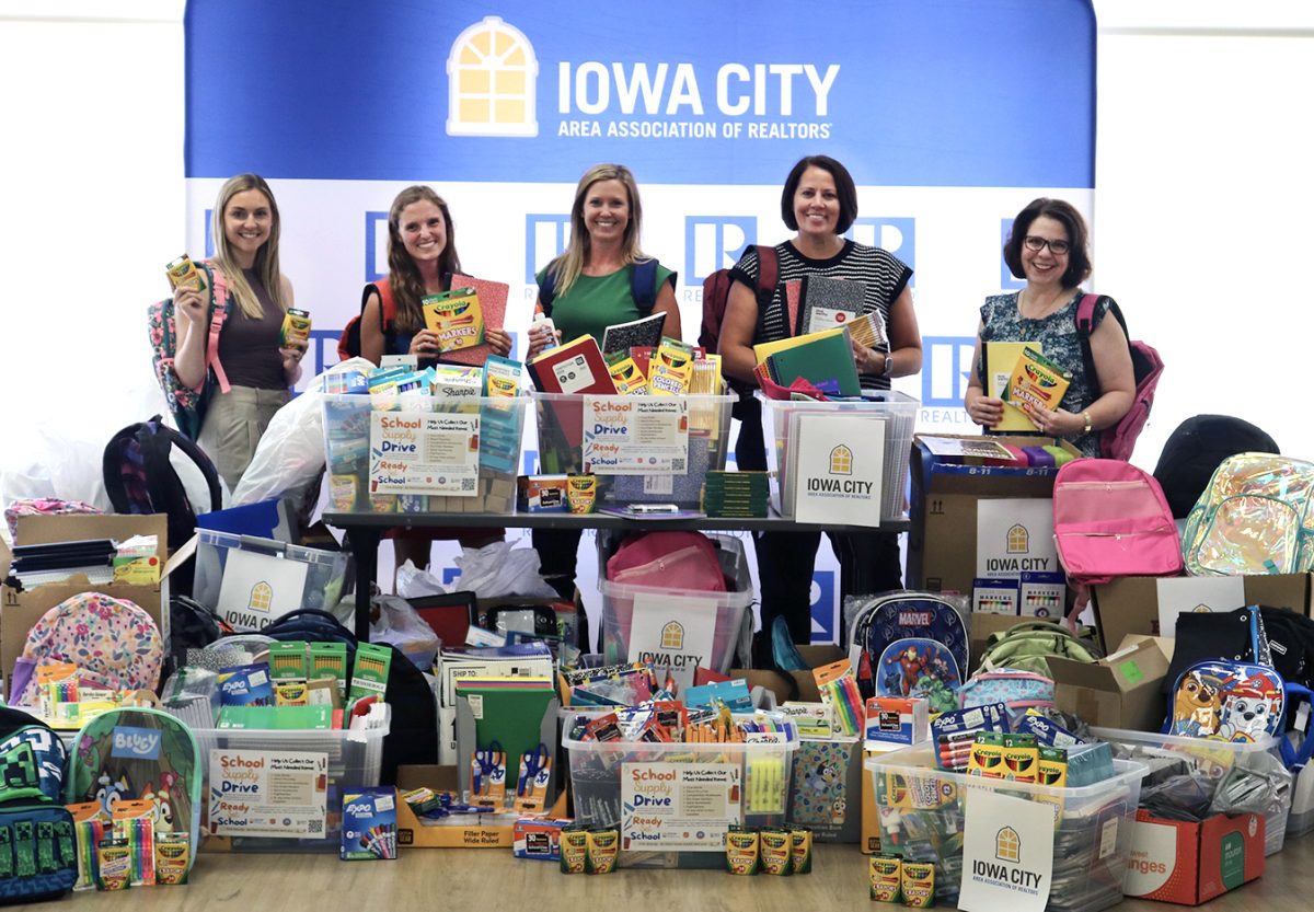 Committee members pose in front of the school supplies collected through ICAAR’s recent donation drive. The supplies will be distributed this weekend at the United Way of Johnson County’s Ready, Set, School event at the Johnson County Fairgrounds.